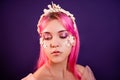 girl with pink hair and professional make-up sea princess with starfish and shells on her face and head