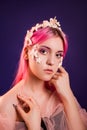 girl with pink hair and professional make-up sea princess with starfish and shells on her face and head