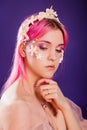 girl with pink hair and professional make-up sea princess with starfish and shells on her face and head