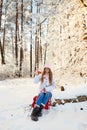 Girl in a pink hat drinking mulled wine in the winter in the forest.