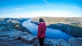 A girl enjoying the fjord view in front of her in Norway.