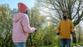 Girl in pink and old man in face mask stand at distance Royalty Free Stock Photo