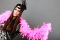 Girl pink plume and black feather on head. Carnival. Royalty Free Stock Photo