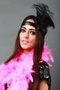 Girl pink plume and black feather on head. Carnival. Royalty Free Stock Photo