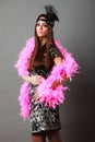 Girl pink plume and black feather on head. Carnival. Royalty Free Stock Photo