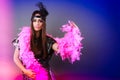 Girl pink plume and black feather on head. Carnival. Royalty Free Stock Photo