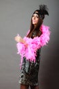 Girl pink plume and black feather on head. Carnival. Royalty Free Stock Photo