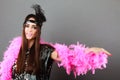 Girl pink plume and black feather on head. Carnival. Royalty Free Stock Photo