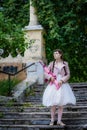 Girl with a pink rifle go up on steps of stairs Royalty Free Stock Photo