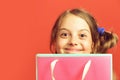 Girl with pink shopping bag. Kid with satisfied face expression