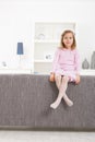 Girl in pink sitting on couch Royalty Free Stock Photo