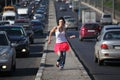 Girl in pink skirt runs on highway middle