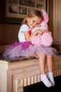 Girl in pink skirt with soft toy
