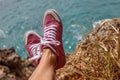 Pink sneakers above the ocean. Bukit, Bali, Indonesia. Royalty Free Stock Photo