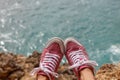 Pink sneakers above the ocean. Bukit, Bali, Indonesia. Royalty Free Stock Photo