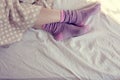 Girl with pink striped socks, sleeping in bed