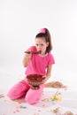 Girl in pink in the studio eating a big spoon jam Royalty Free Stock Photo