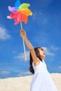 Girl with pinwheel on beach