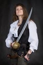 The girl - pirate with a sabre in hands Royalty Free Stock Photo