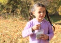 Girl with plaits eating seeds