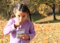 Girl with plaits eating seeds