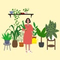 Girl is standing among plants. Everyday life of young woman with yellow watering can taking care for houseplant Royalty Free Stock Photo