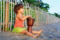 Girl play ethnic music on traditional african hand drum djembe