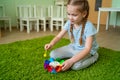 Girl play with whirligig colourful musical bells