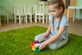 Girl play with whirligig colourful musical bells