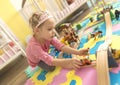 Girl play with a wooden set Royalty Free Stock Photo