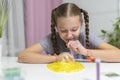 Girl play with yellow slime inflates bubble fun at home