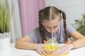 Girl play with yellow slime inflates bubble fun at home