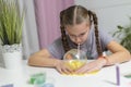 Girl play with yellow slime inflates bubble fun at home