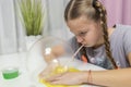 Girl play with yellow slime inflates bubble fun at home