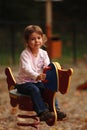 Girl on playground toy Royalty Free Stock Photo