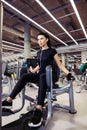 Adduction or abductor machine. girl exercising her legs in gym