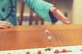 A girl playing a board game and rolls dice. Hand throws the dice on the background of colorful blurred fantasy Board games, gaming Royalty Free Stock Photo