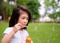 A girl playing with bubbles, blowing them into the air Royalty Free Stock Photo