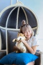 A girl playing with a cat on the large sofa. Young woman playing with kitten on sofa at home Royalty Free Stock Photo