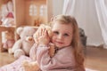 Girl playing in children`s room. Baby with toy bear. Children`s playroom. Educational toys. Early child development Royalty Free Stock Photo