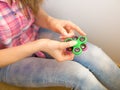 Girl playing with a colourful hand fidget spinner toy Royalty Free Stock Photo