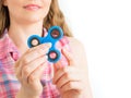 Girl playing with a colourful hand fidget spinner toy Royalty Free Stock Photo