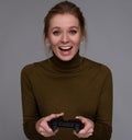 Girl playing computer game with a gamepad Royalty Free Stock Photo