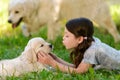 Girl playing with dog`s neb