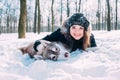 Girl playing with dog in snow