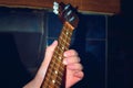 The girl is playing dombra and beating the chords on the guitar, close-up.