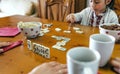 Girl playing domino with her family Royalty Free Stock Photo