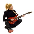 Girl playing an electric guitar sitting down Royalty Free Stock Photo