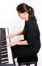 Girl playing on electric piano Royalty Free Stock Photo
