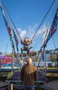 Girl playing at the carnival attraction with father